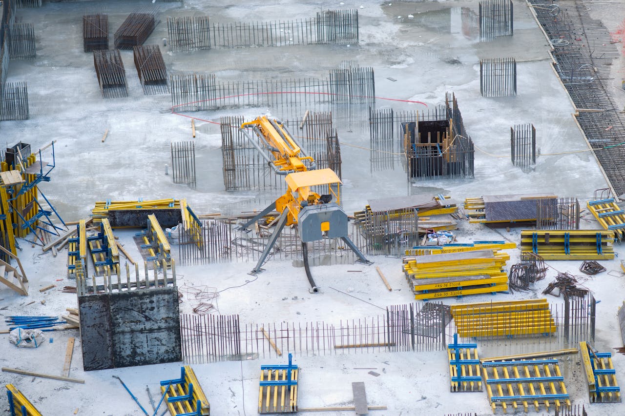 Crafting Captivating Headlines: Your awesome post title goes here Aerial view of an active construction site with heavy machinery and building materials.